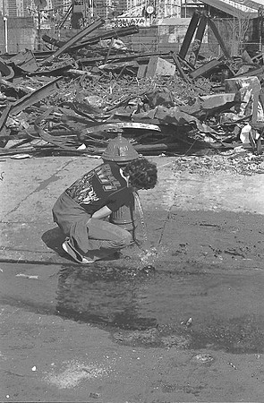 Stefan takes a drink in front of the remains of the Tornado, March 1978
